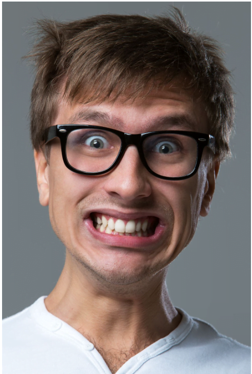 man with glasses showing teeth 