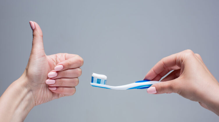 toothbrush held by a woman